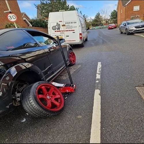Car with red alloys tyre change